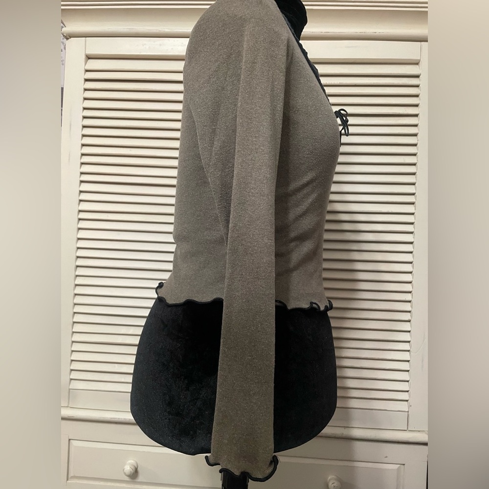 Long sleeve olive green top with black trim.